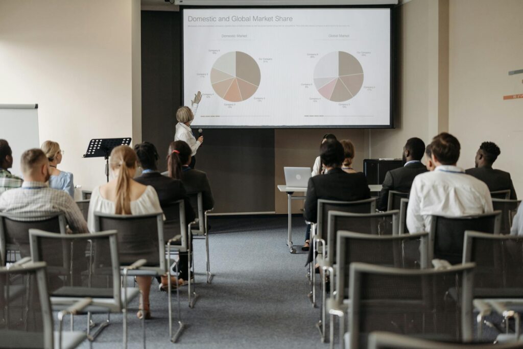 A team of financial analysts in a modern office looking at complex cryptocurrency market data on a large monitor.