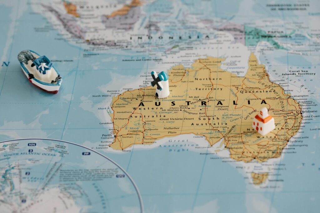 A close-up of a physical Bitcoin placed over a map of the world, illustrating its global reach.