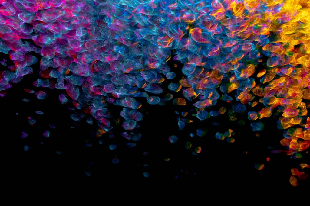 A person's hands typing on a laptop displaying complex cryptocurrency candlestick charts.