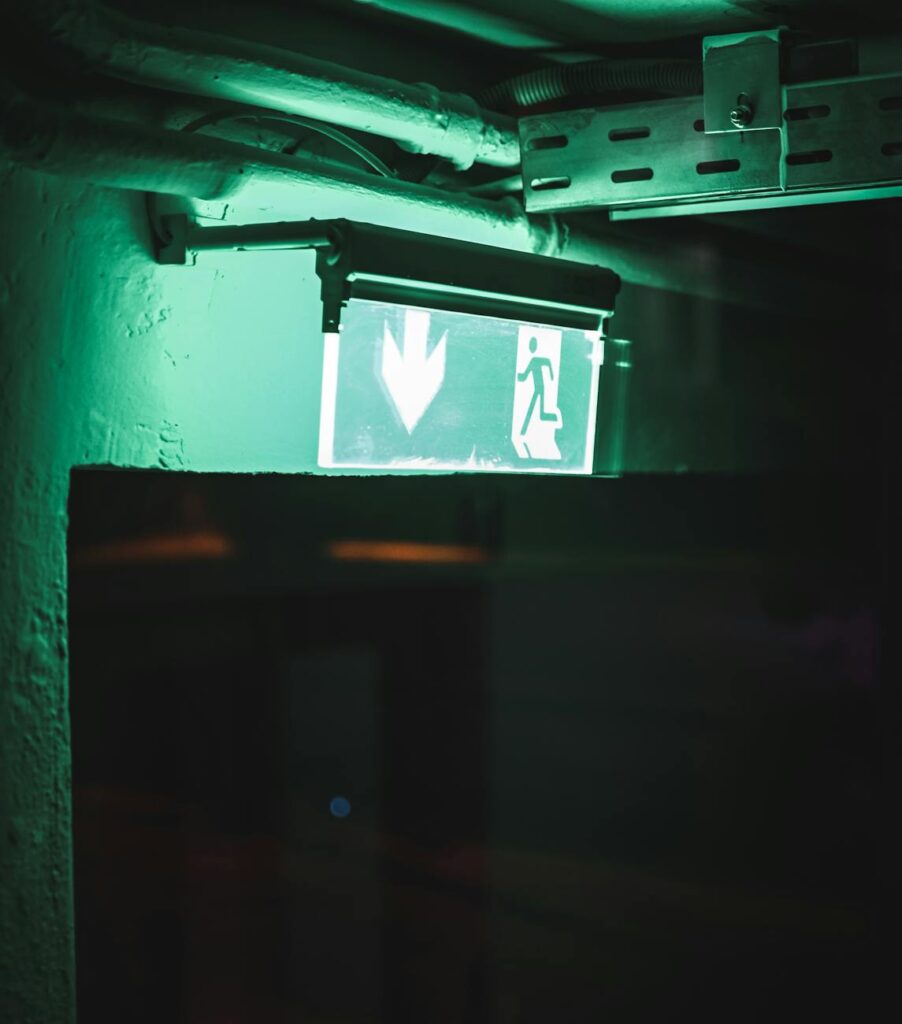 A 3D rendering of a complex, dark maze with a single glowing pathway, illustrating the security challenges of interoperability.