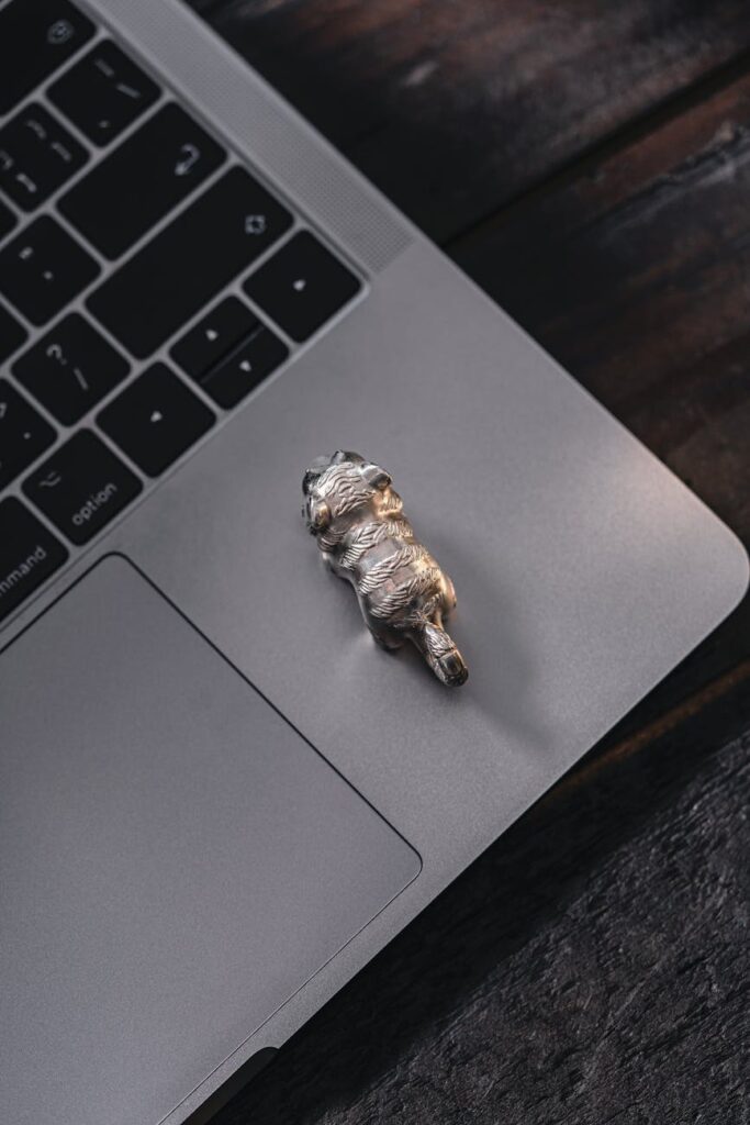 A person's hands connecting cables to a small DePIN hardware node on a wooden desk.