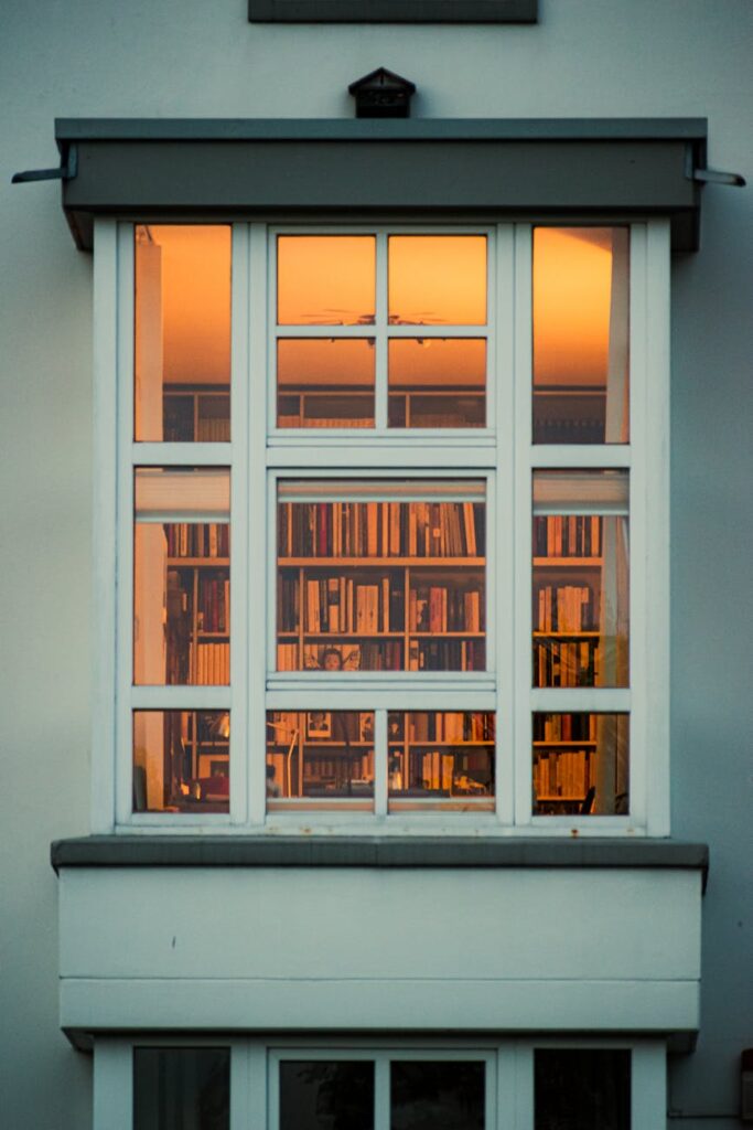 A developer or lawyer looking intently at a laptop screen displaying lines of code and cryptocurrency price charts.