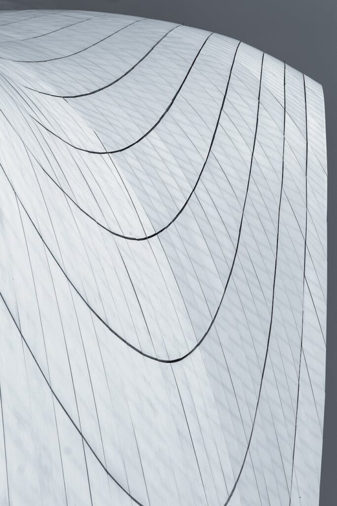 A physical Ethereum coin illuminated with a blue glow, resting on a complex computer motherboard.