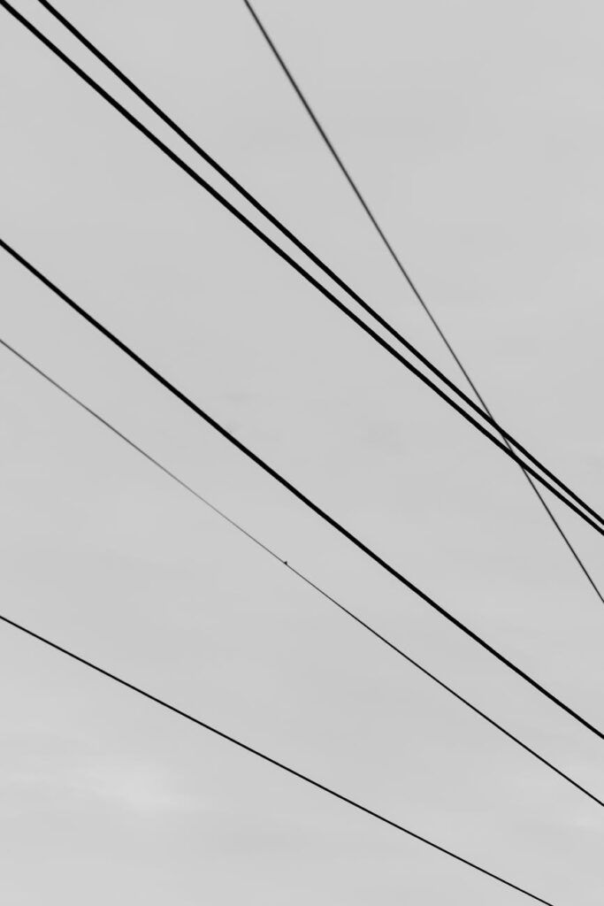 A programmer or trader in a dark room illuminated by screens showing complex cryptocurrency market data and graphs.