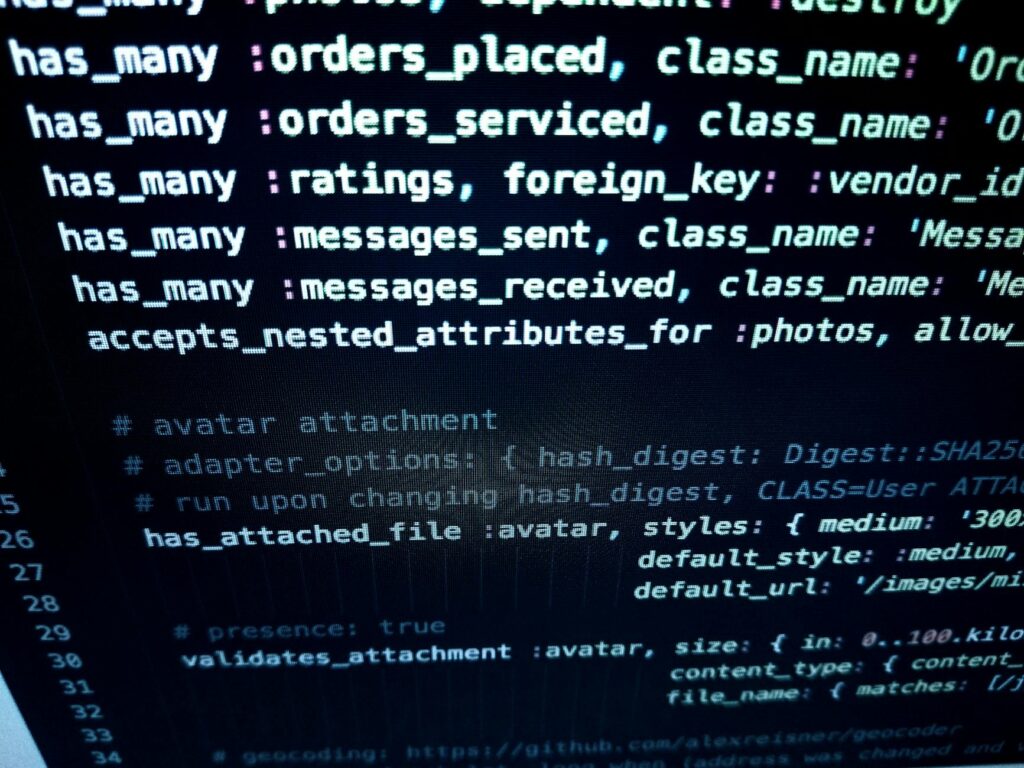 A developer's hands typing Move programming language code on a dark-themed monitor, showcasing the creation of a smart contract.