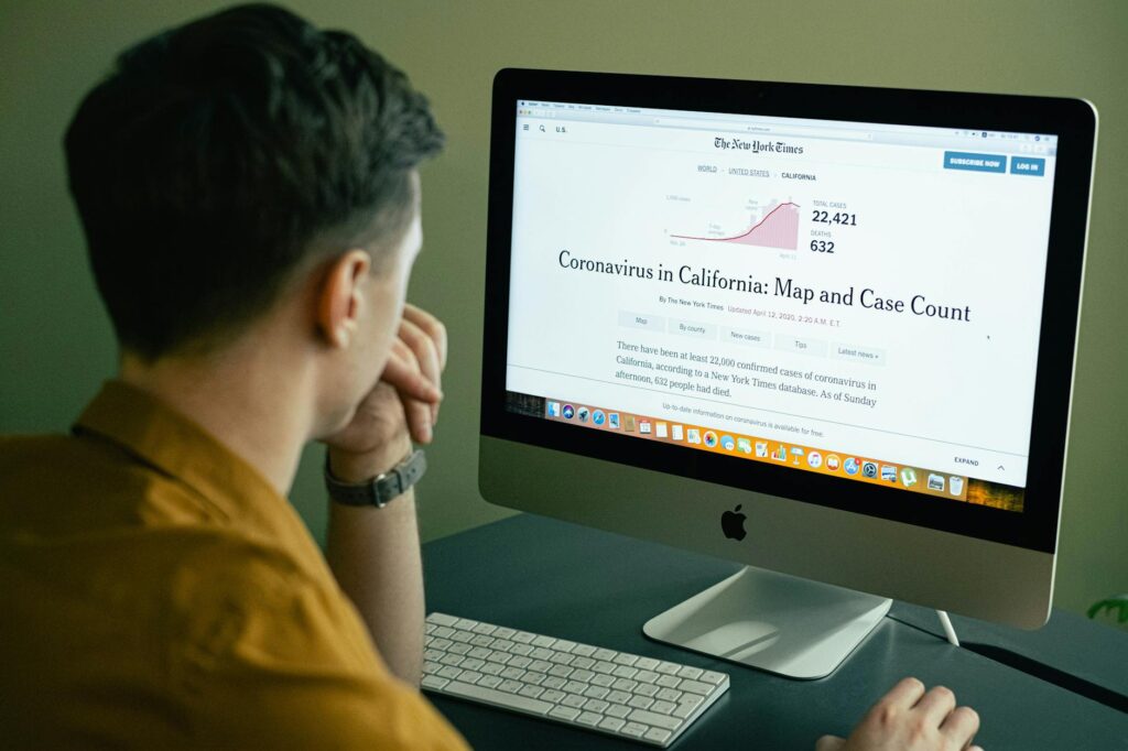 A crypto analyst looking intently at charts and code on a multi-monitor setup in a dimly lit room.