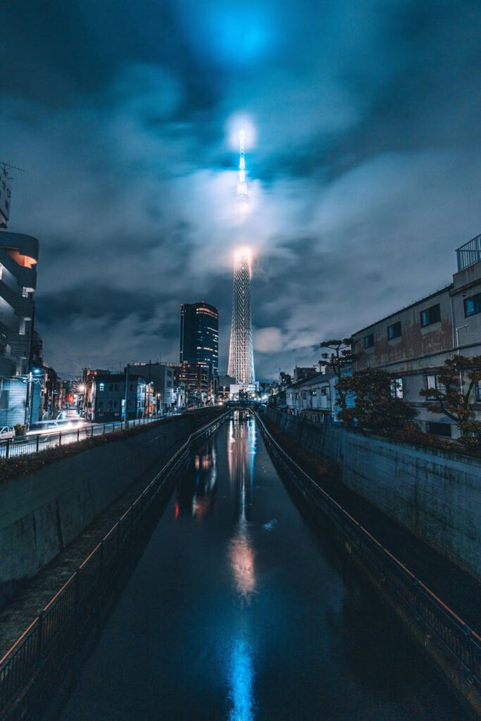 A futuristic city at night with digital data streams flowing between buildings, symbolizing permissionless transactions.
