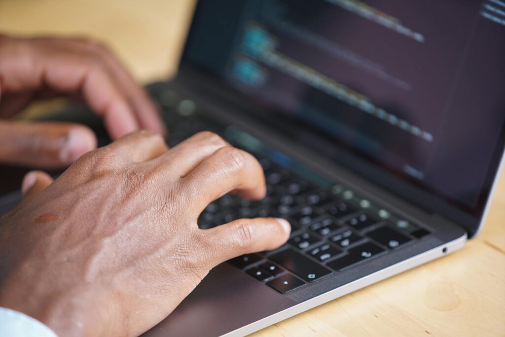 A developer, representing an MEV searcher, analyzing market data on several monitors.