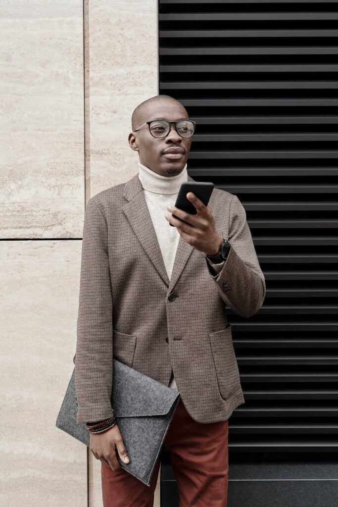 A close-up of a person's hands holding a smartphone displaying a cryptocurrency portfolio app.