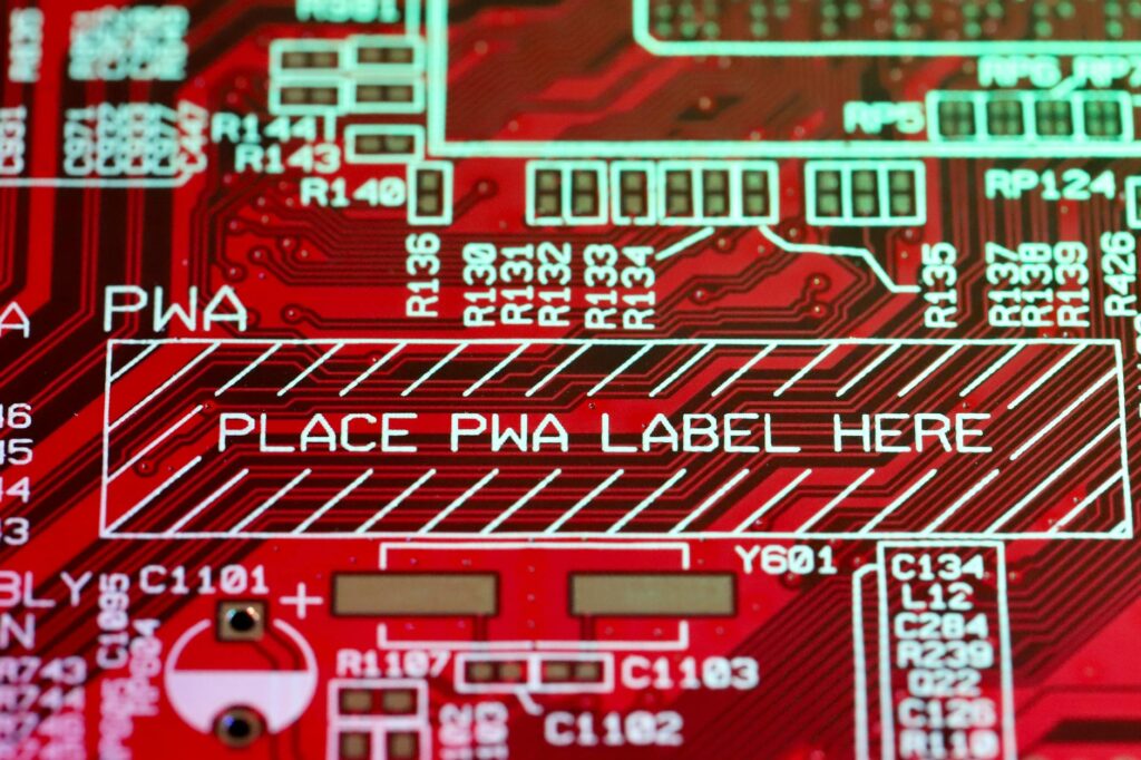 A close-up of a physical Ethereum coin resting on a green circuit board.