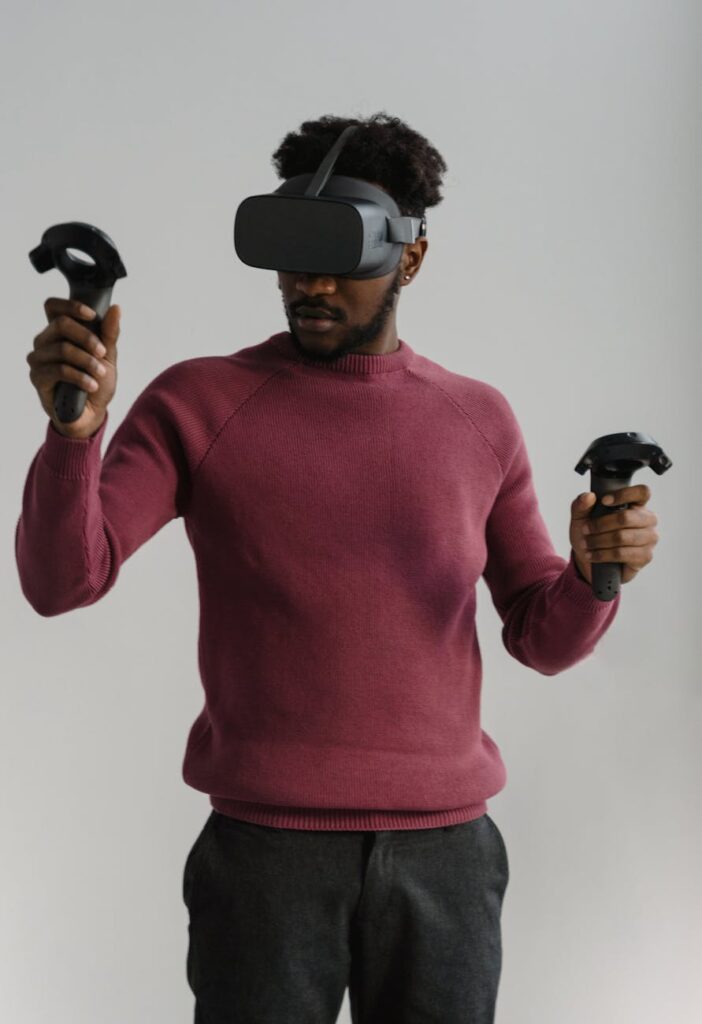 A person looking at a digital art gallery displaying various NFTs on a large, high-resolution monitor.