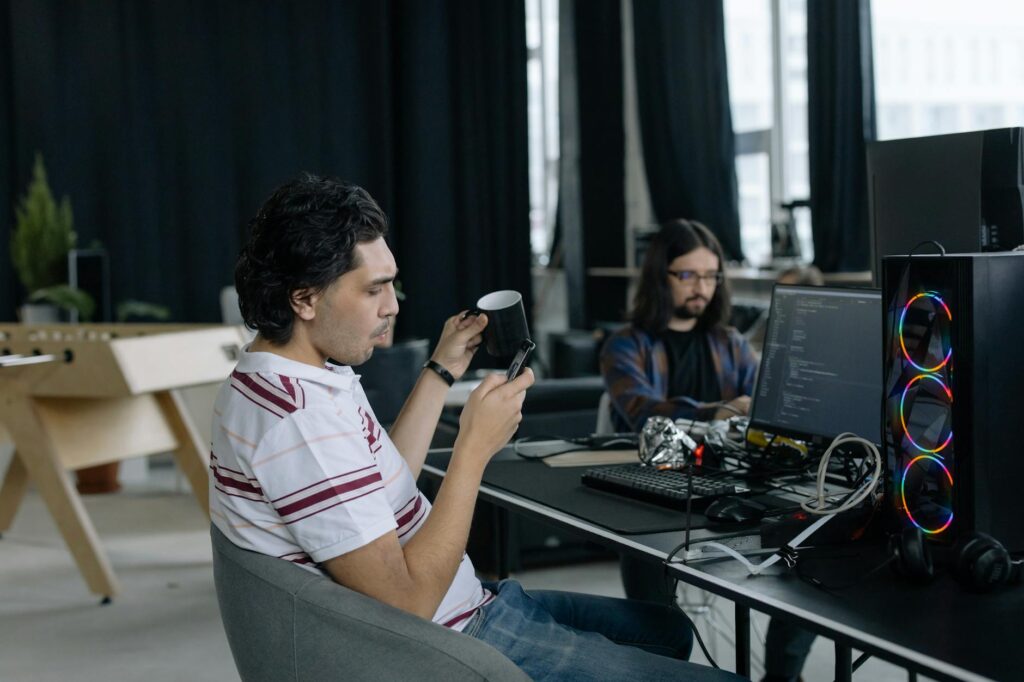 A diverse group of developers working together in a modern office, with blockchain schematics in the background.