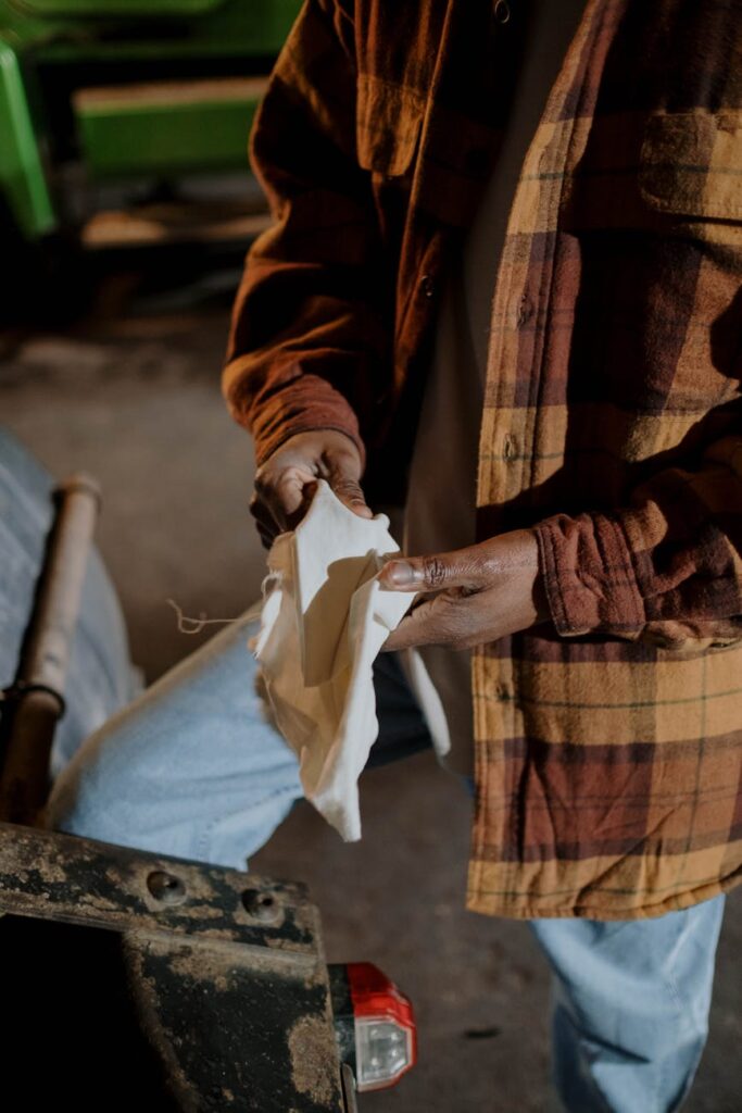 A person's hand holding a sleek black hardware wallet for cryptocurrency self-custody.