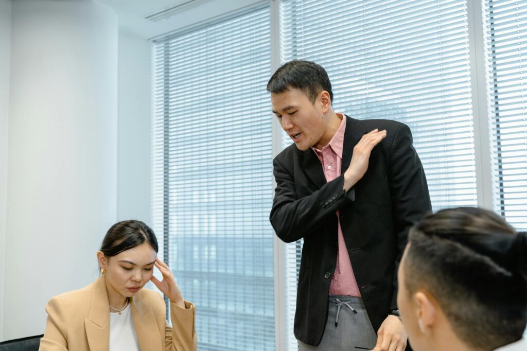 A diverse group of professionals at a boardroom table discussing charts and graphs related to financial risk.