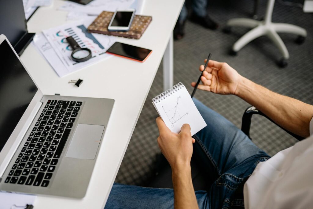 A group of financial professionals in a modern office discussing a presentation on institutional digital asset investment.