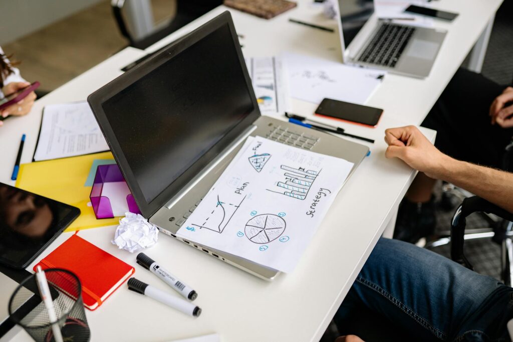A senior individual looking at a retirement portfolio on a laptop screen showing diversified asset allocation.