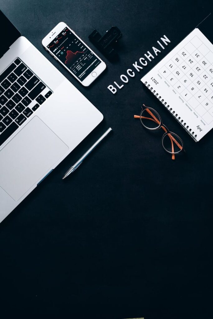 A photo of a tokenized real estate contract document lying next to physical Bitcoin and Ethereum coins.