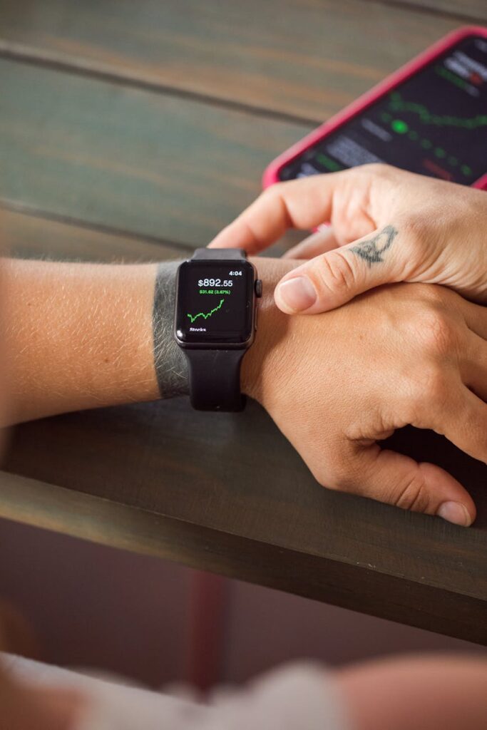 A silhouette of an investor analyzing complex financial data on a multi-monitor setup.