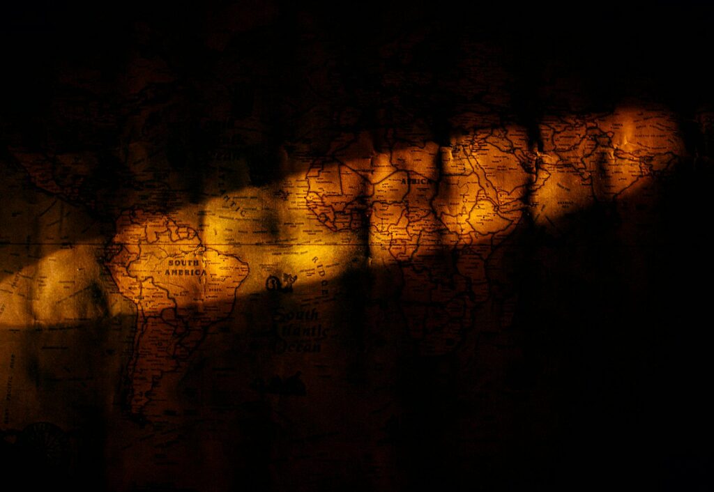 A digital map of the world with glowing points of light showing the spread of a blockchain network.